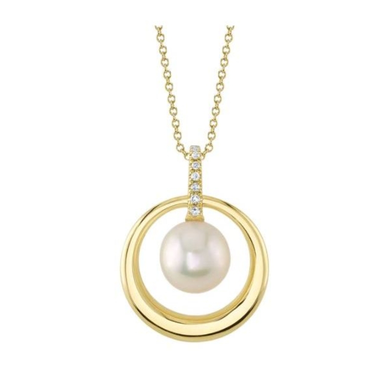 A 14K Yellow Gold Open Circle Pendant That Is Set In The Center